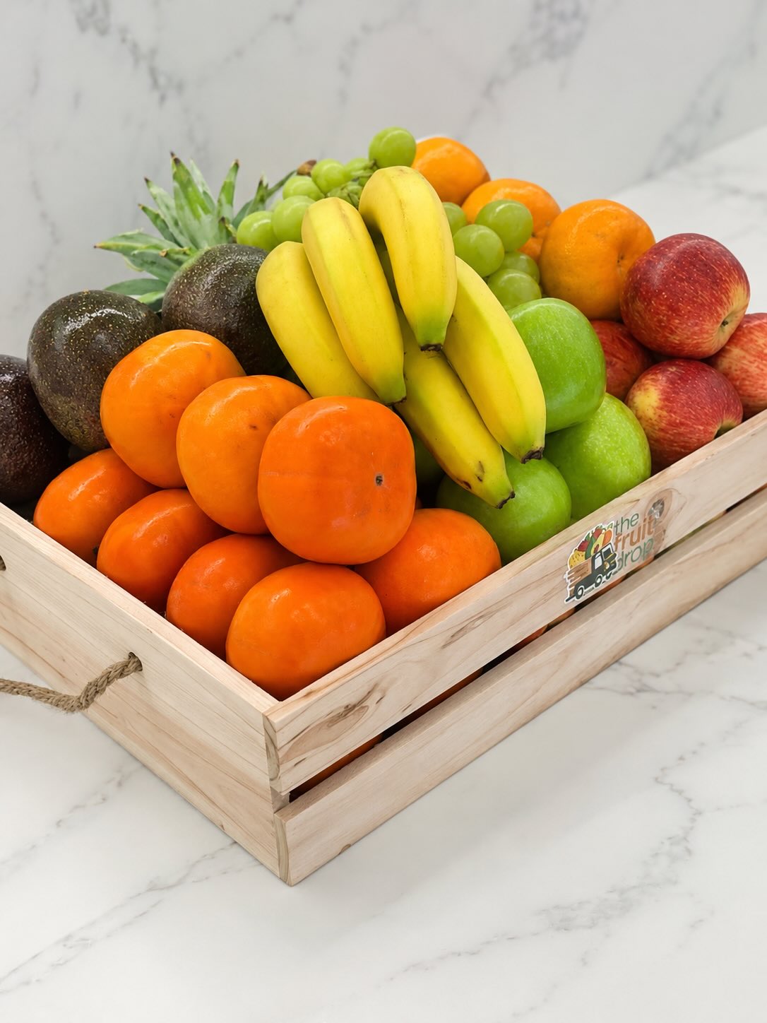 Premium fruit hamper with avocados, persimmons, bananas, grapes and apples