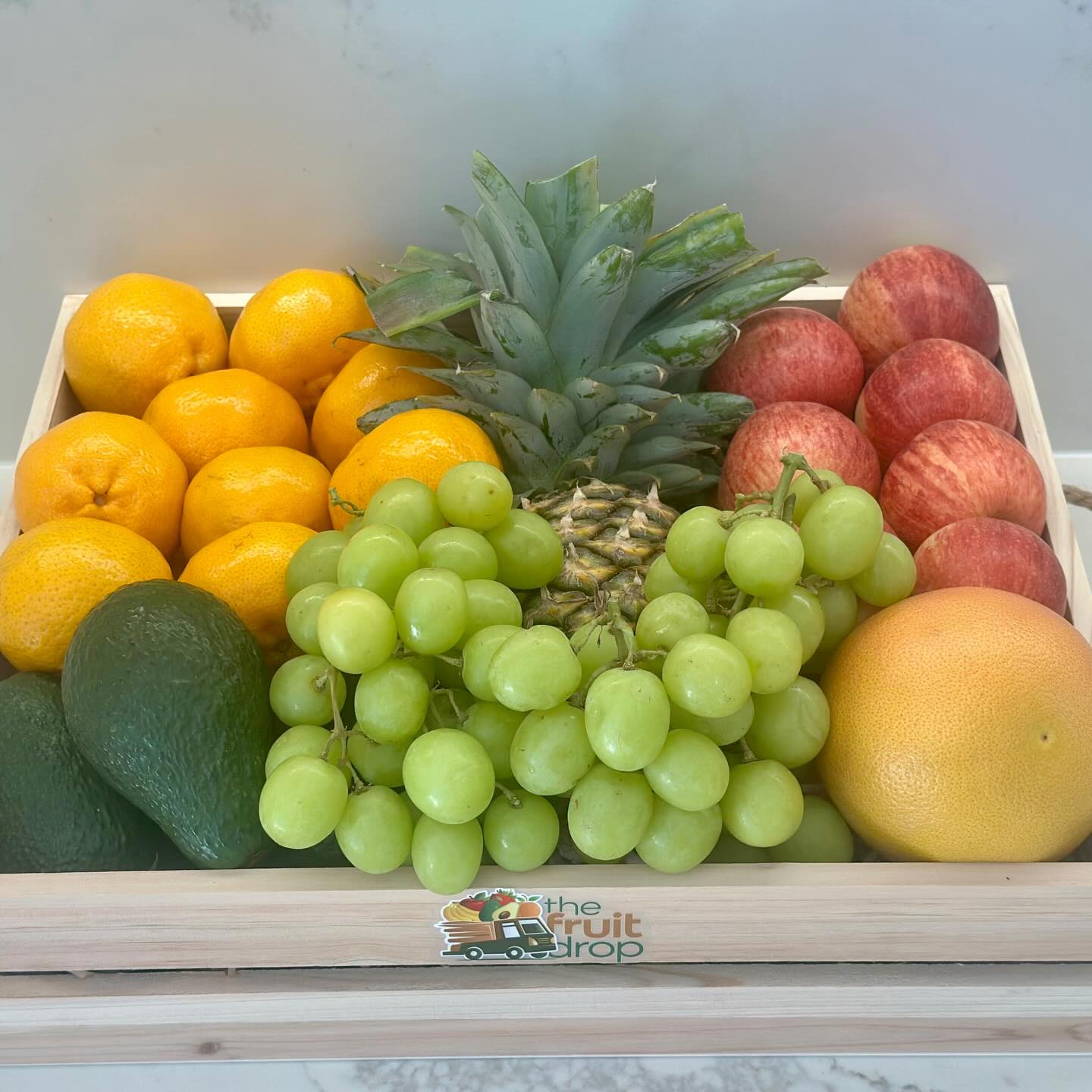 Mixed fruit gift tray with pineapple, grapes, apples and mandarins